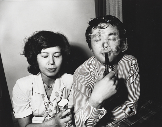 Woman and Man smoking pipe both with eyes closed